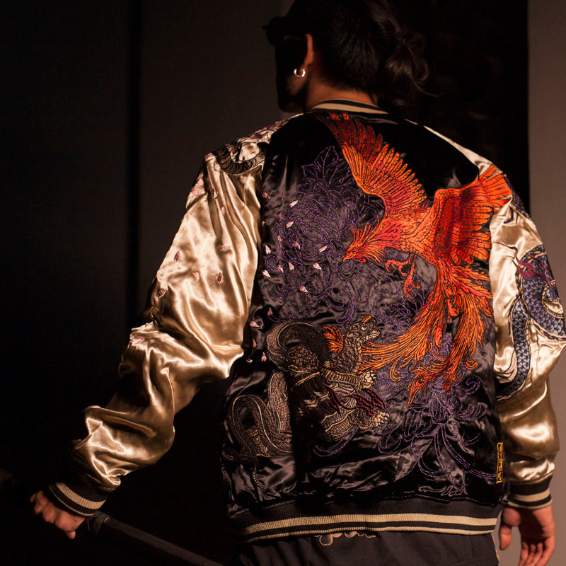 Artistic photo of men’s embroidered satin bomber in low light