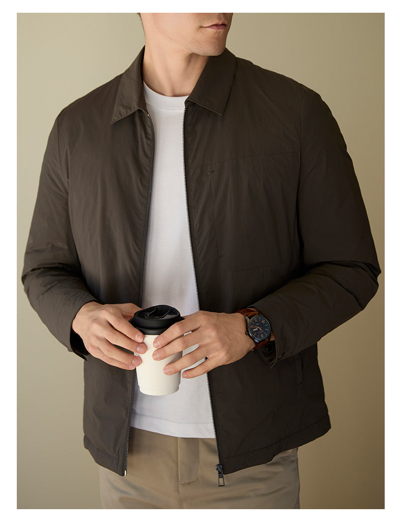 Lifestyle photo of a man confidently wearing the black goose down jacket outdoors