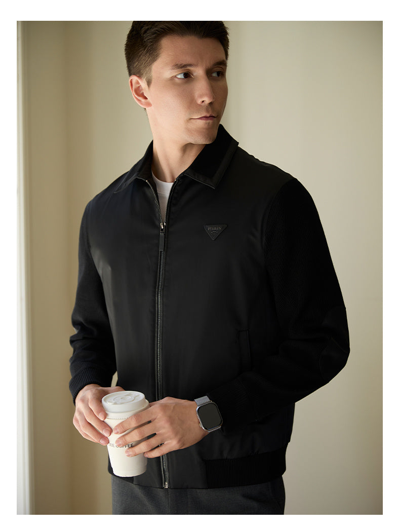 Close-up of the zippered placket and splicing design on a men's casual jacket.