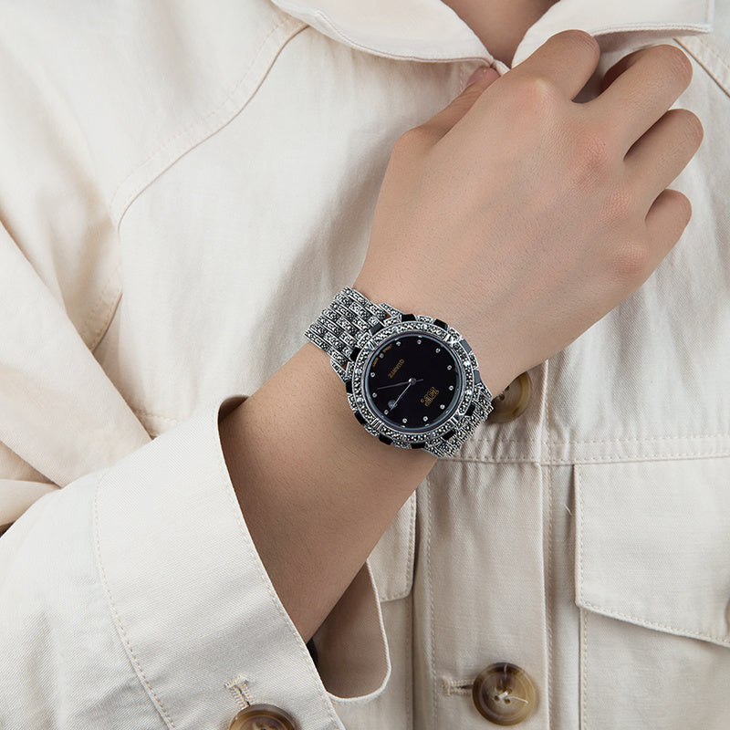 Detailed view of the black dial European luxury quartz watch with a metal band.