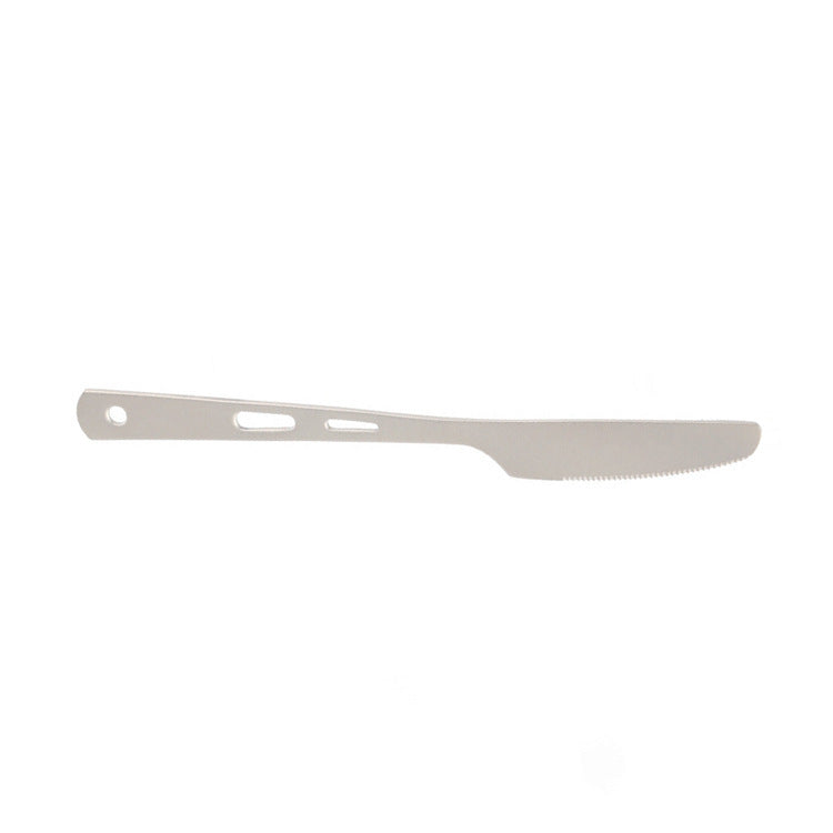 Complete titanium cutlery set displayed on rustic wooden surface