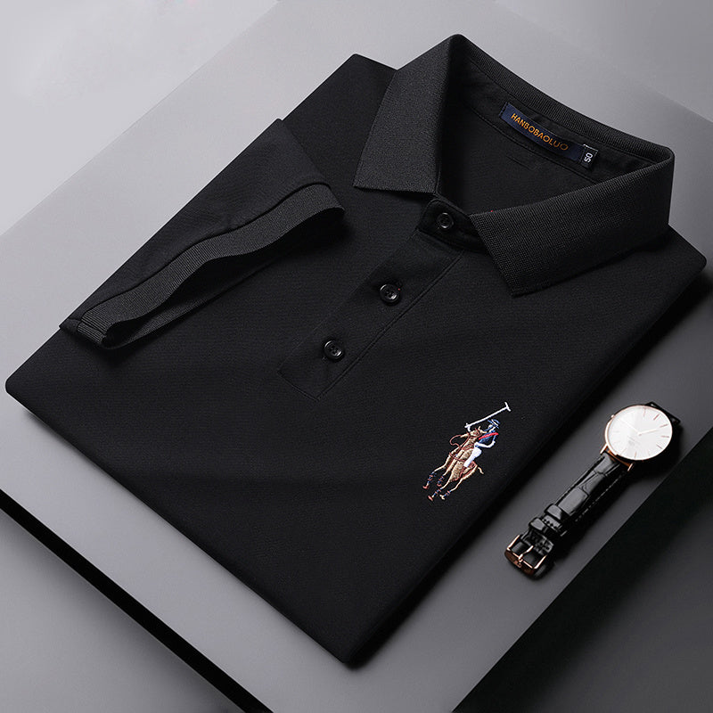 Side angle view of model wearing gray embroidered cotton polo shirt