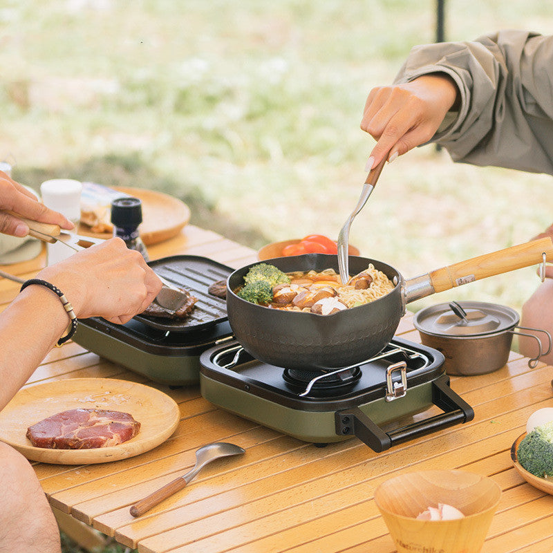 Compact and lightweight dual-burner folding gas stove for camping and picnics.