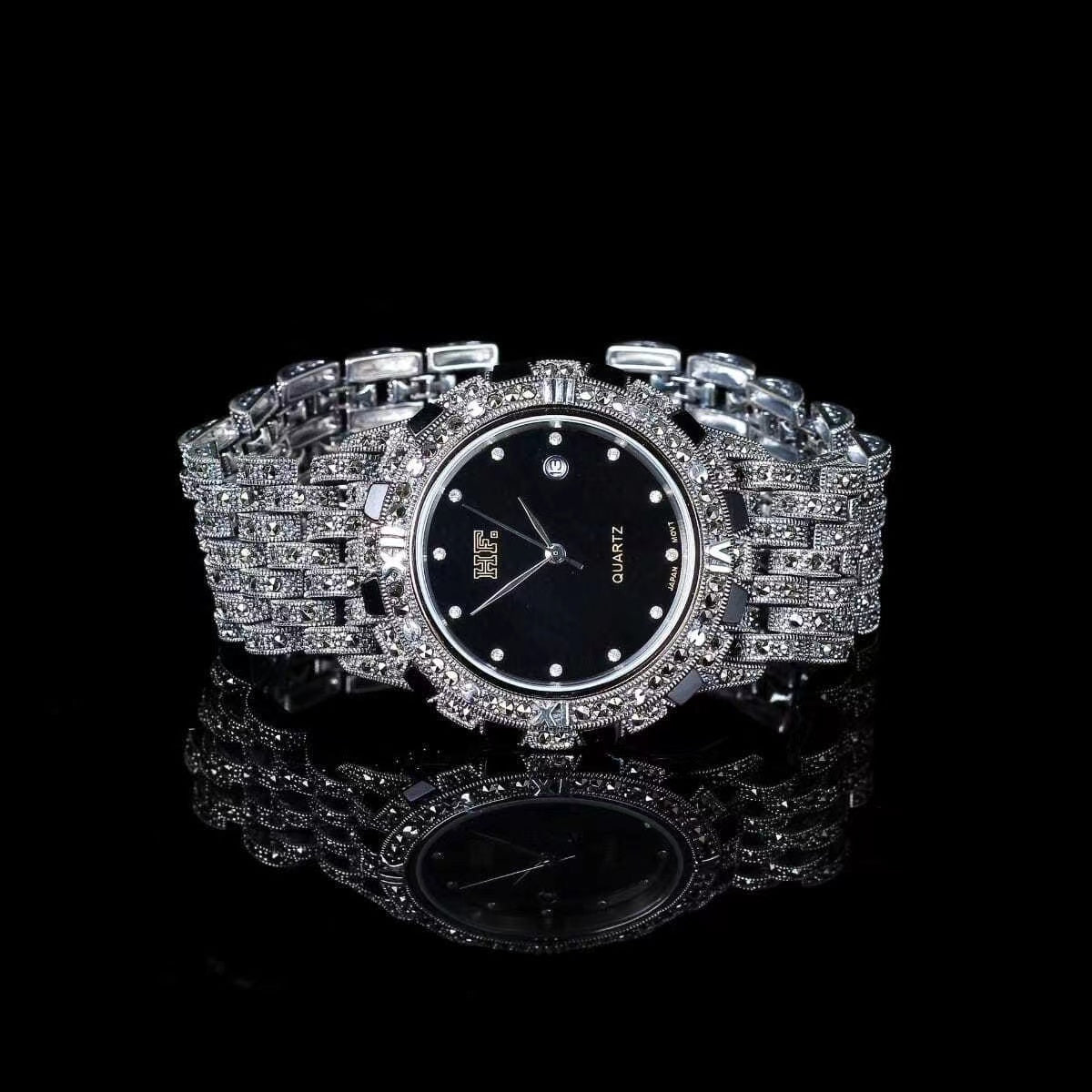 Stylish metal band watch with decorative jeweled clasp for a secure fit.