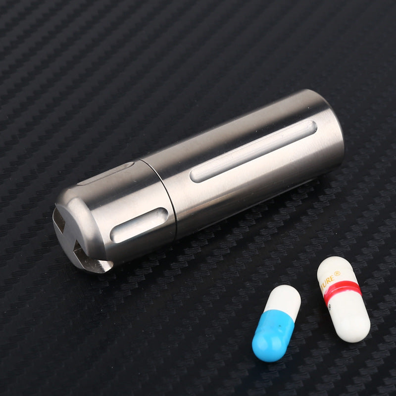 Close-up of stonewashed titanium pill container with aged finish