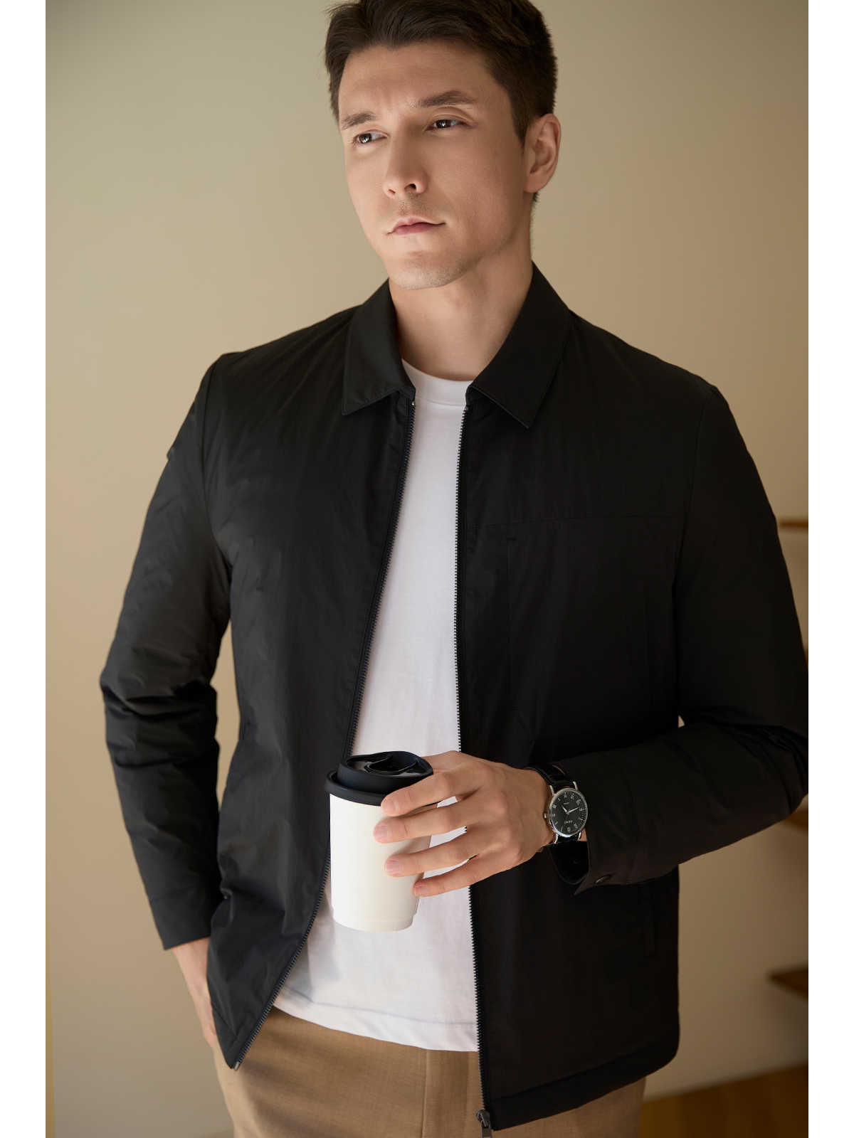Man wearing the goose down short coat in an urban setting for a sleek winter look