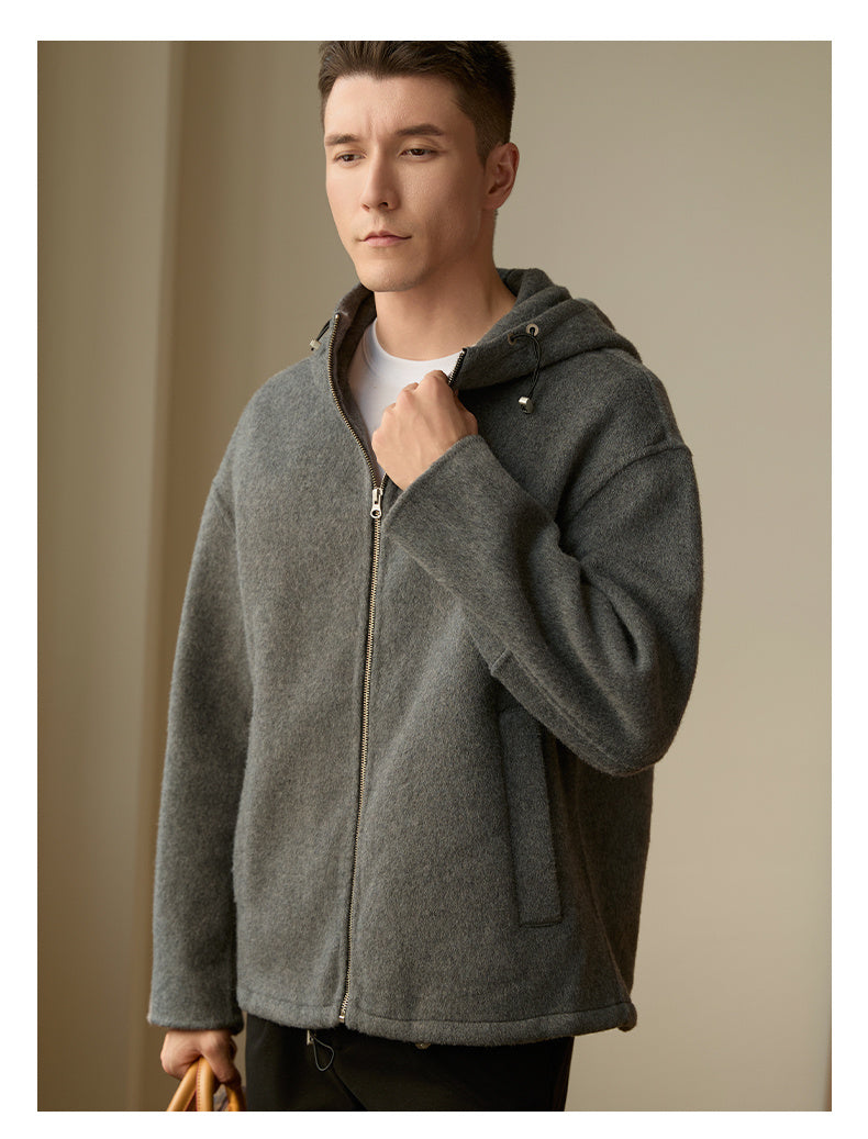 Back view of the men’s woolen coat in medium gray highlighting the relaxed design and hood detail.