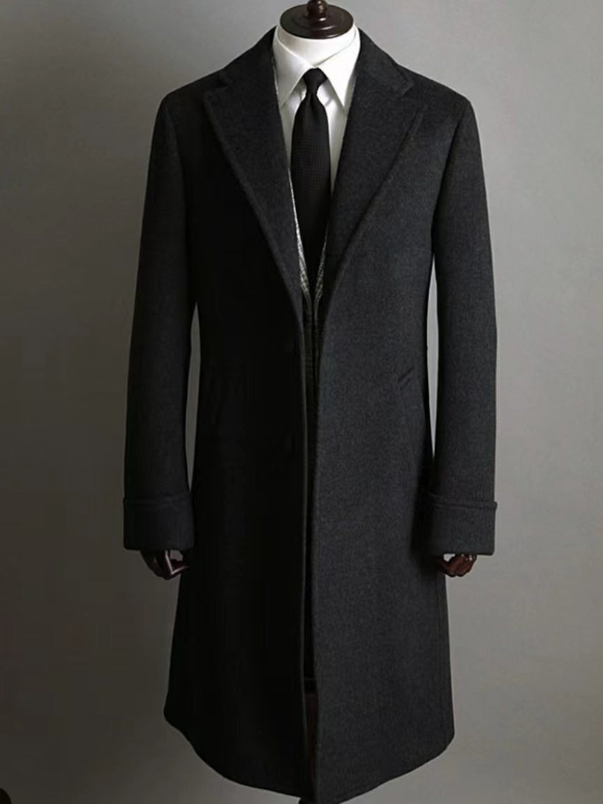 Close-up of double-breasted buttons on black men’s cashmere coat
