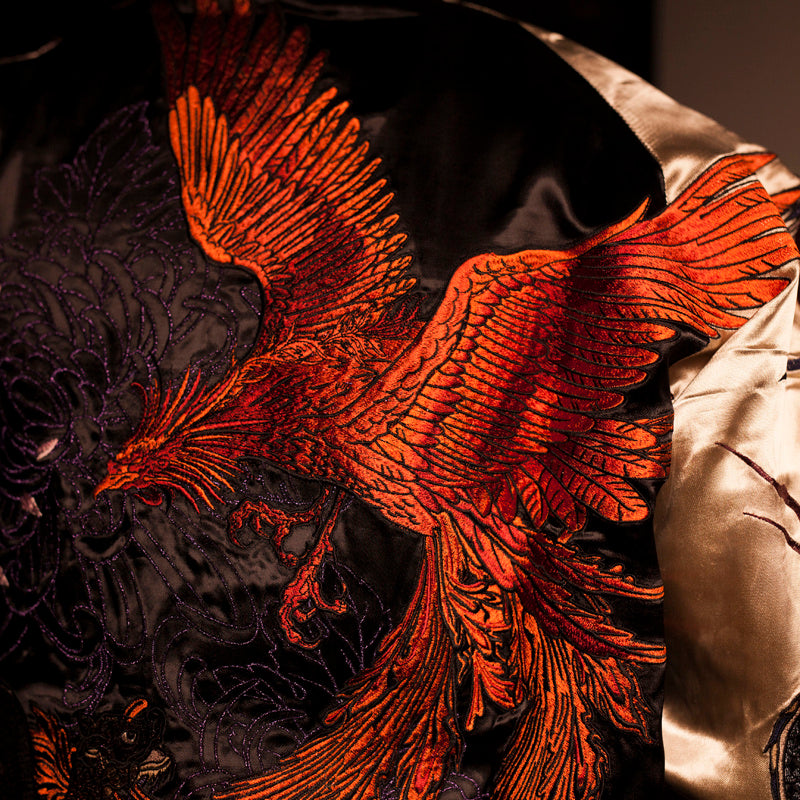 Detailed embroidery of a dragon on men’s satin bomber jacket
