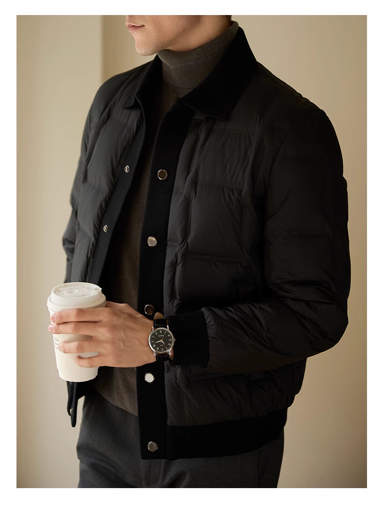 Detailed close-up of the patchwork fabric and sleek black finish on men’s coat