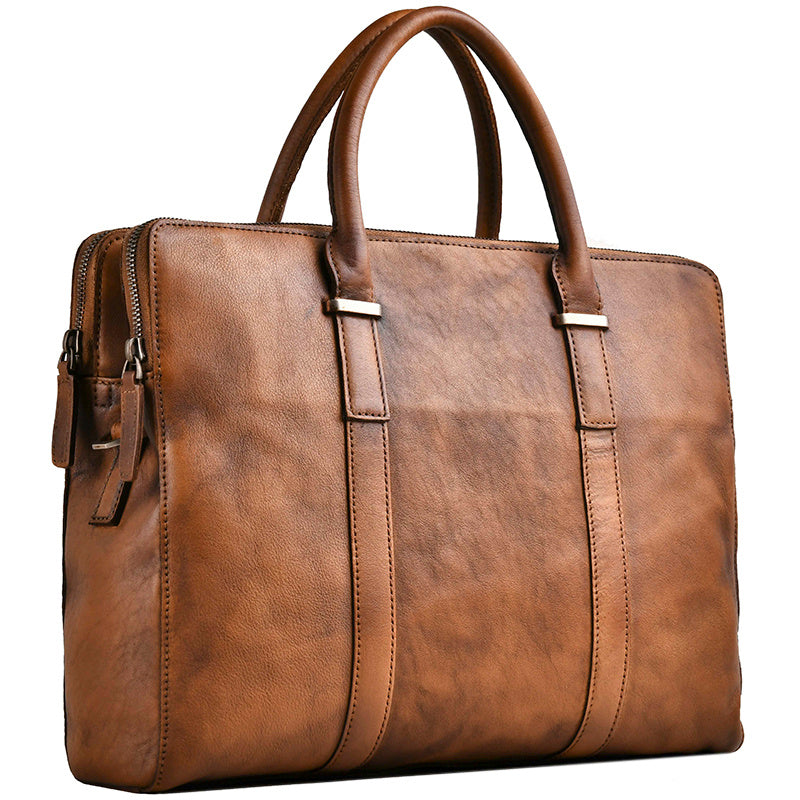 Soft leather handle detail of the vintage vegetable-tanned men's handbag for comfortable carrying.