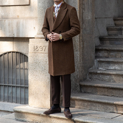Dark brown double-breasted wool coat shown flat, emphasizing the classic design, premium fabric blend, and tailored fit for elegant winter wear.