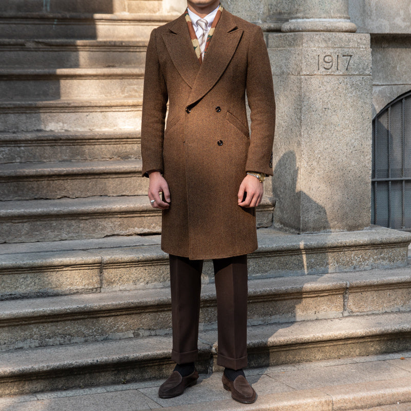 Double-breasted wool coat in dark brown with a blazer-style collar, showcasing its timeless and refined design.