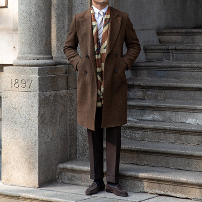 Dark brown wool coat styled on a mannequin, displaying its notched lapel collar and warm, elegant design.