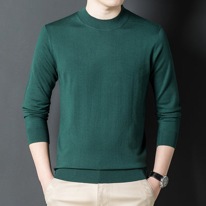 Stack of folded cashmere sweaters in black, camel, green, and blue