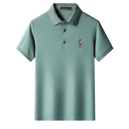 Green embroidered polo tee worn with jeans for casual outfit