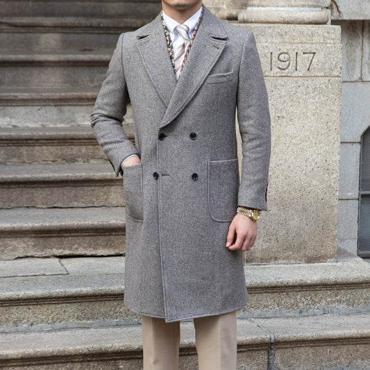 Elegant grey double-breasted wool coat with a tailored blazer-style collar, highlighting its timeless design and premium fabric blend.