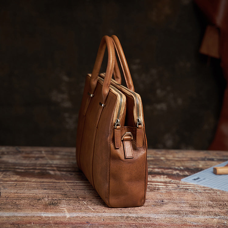Spacious interior of the vintage men's handbag with multiple compartments for laptops, phones, and documents.