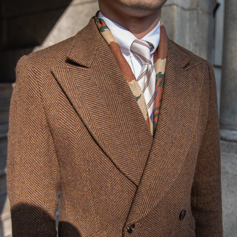 Dark brown double-breasted wool coat shown with detailed stitching, perfect for a refined winter look.