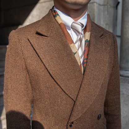 Dark brown double-breasted wool coat shown with detailed stitching, perfect for a refined winter look.