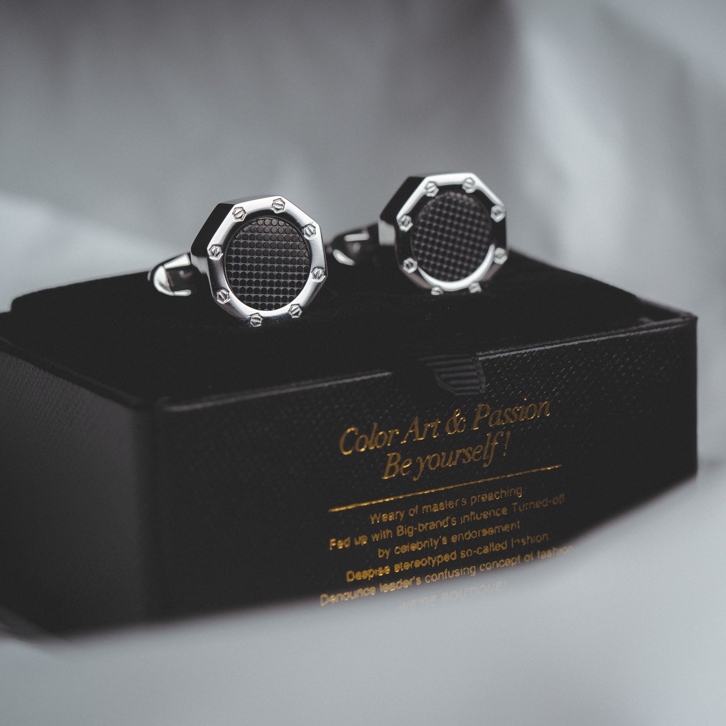 Close-Up of Polished Silver Steel Cufflinks with Black Accents