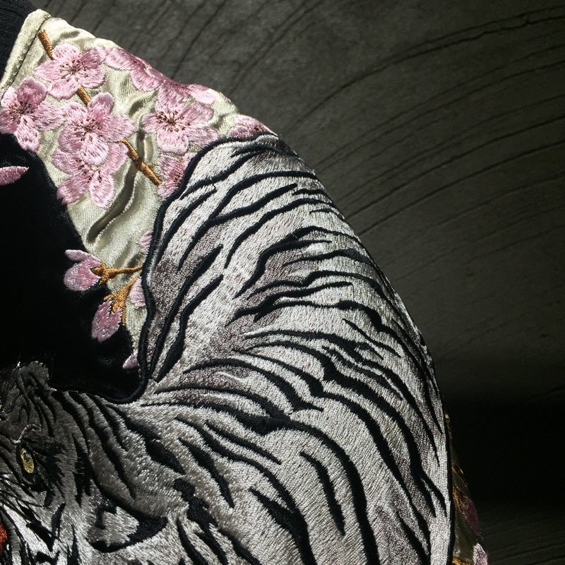 Close-up of embroidered sleeve on men’s double-sided bomber jacket