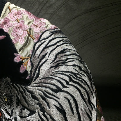 Close-up of embroidered sleeve on men’s double-sided bomber jacket