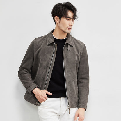 Man styled in suede leather jacket walking through urban setting