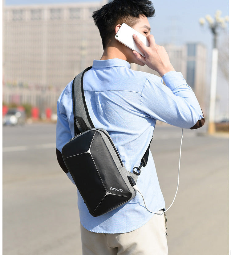 Dual strap travel shoulder bag for men shown in urban setting