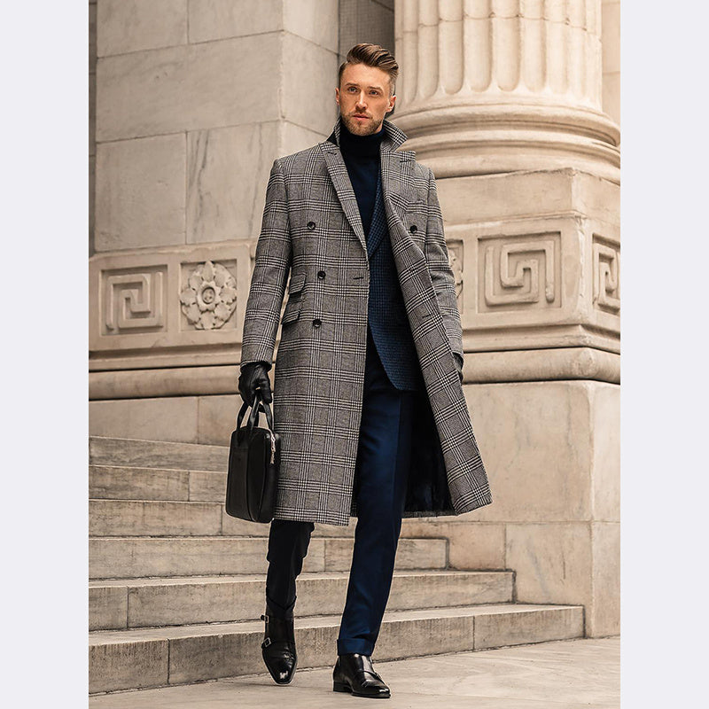 Stylish man wearing a closed gray checkered overcoat, standing confidently near a Roman-style courthouse or government building.