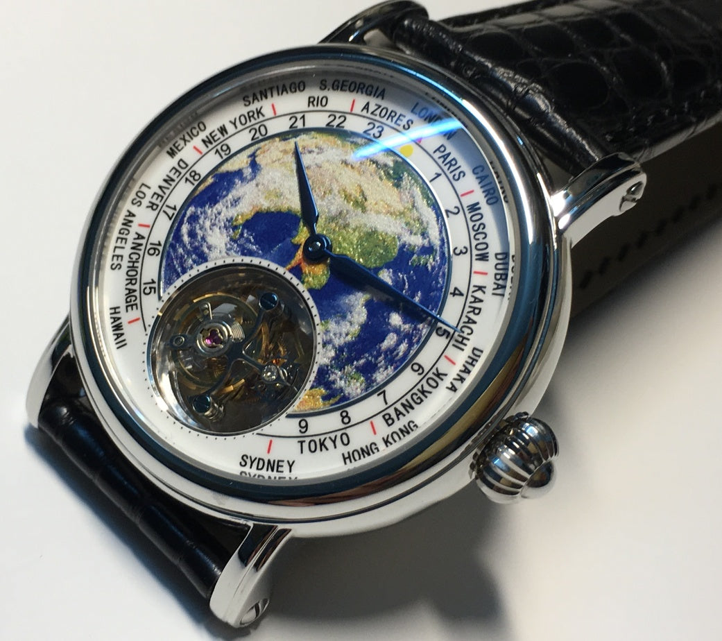 Front view of the tourbillon watch with a world map dial and visible open-heart movement.