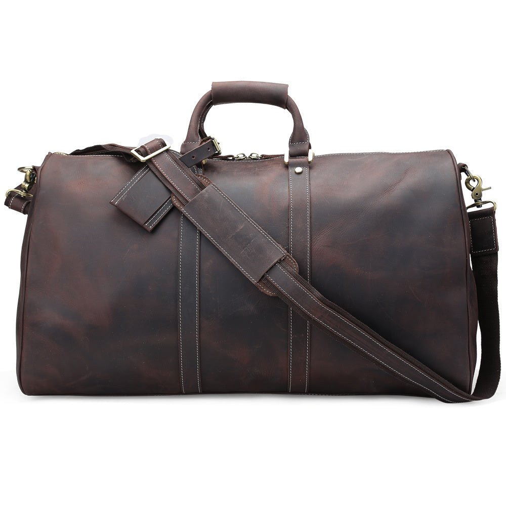 Side view of the authentic cowhide travel bag showcasing its vintage design and long side.